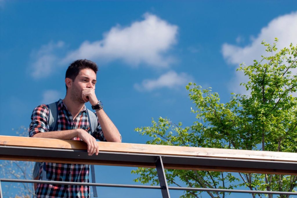 lagunashoresrecovery-Traveling-to-Rehab-–-Pros-and-Cons-photo-of-a-thoughtful-man