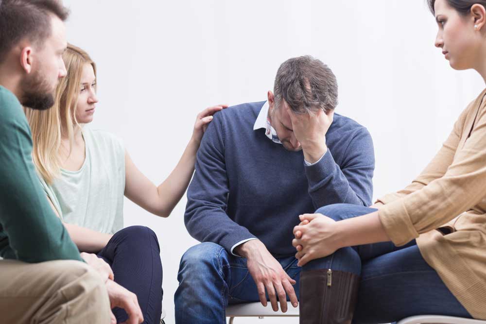 lagunashoresrecovery 7 Early Warning Signs of Substance Use Disorder photo of Woman is cheering up her friend during therapy