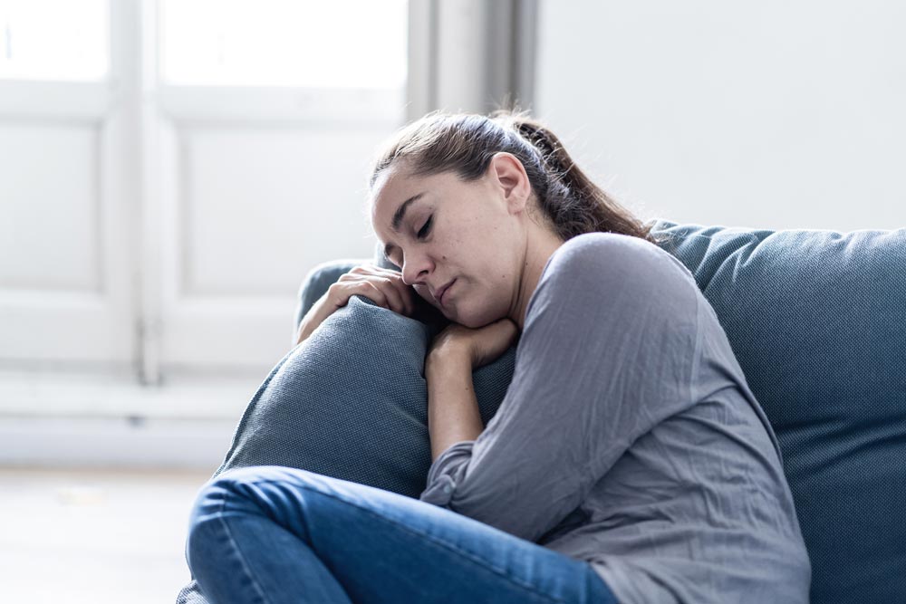 lagunashoresrecovery Common and Rare Side Effects of Xanax photo of woman lying in the couch feeling restless
