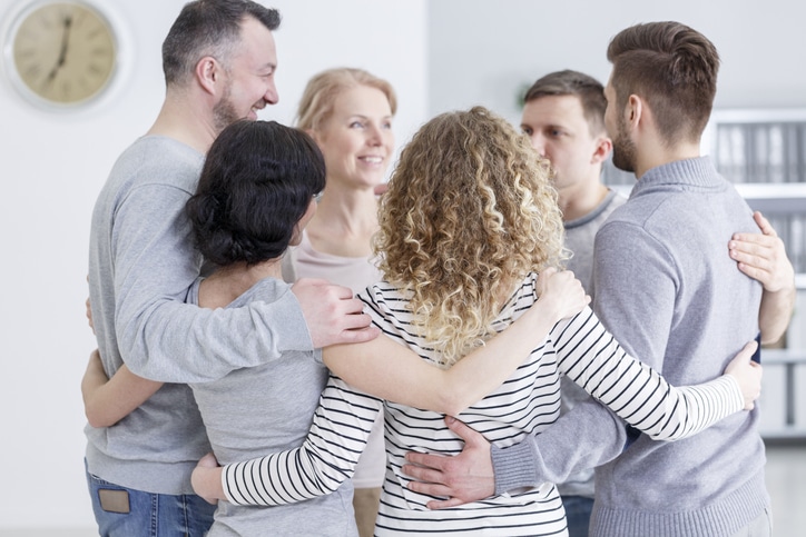 a group of adults making a circle